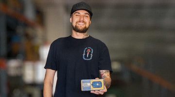 standing man smiling with blurred background