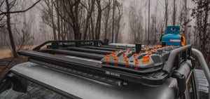 ARB baserack roof rack on a vehicle in front of a forest