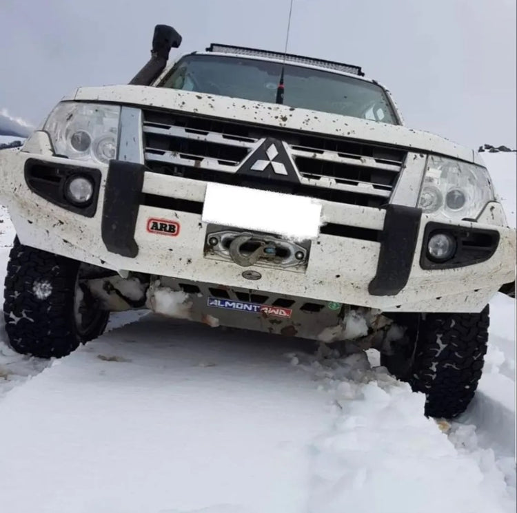 White Pajero in the snow with arb bumper and engine guard
