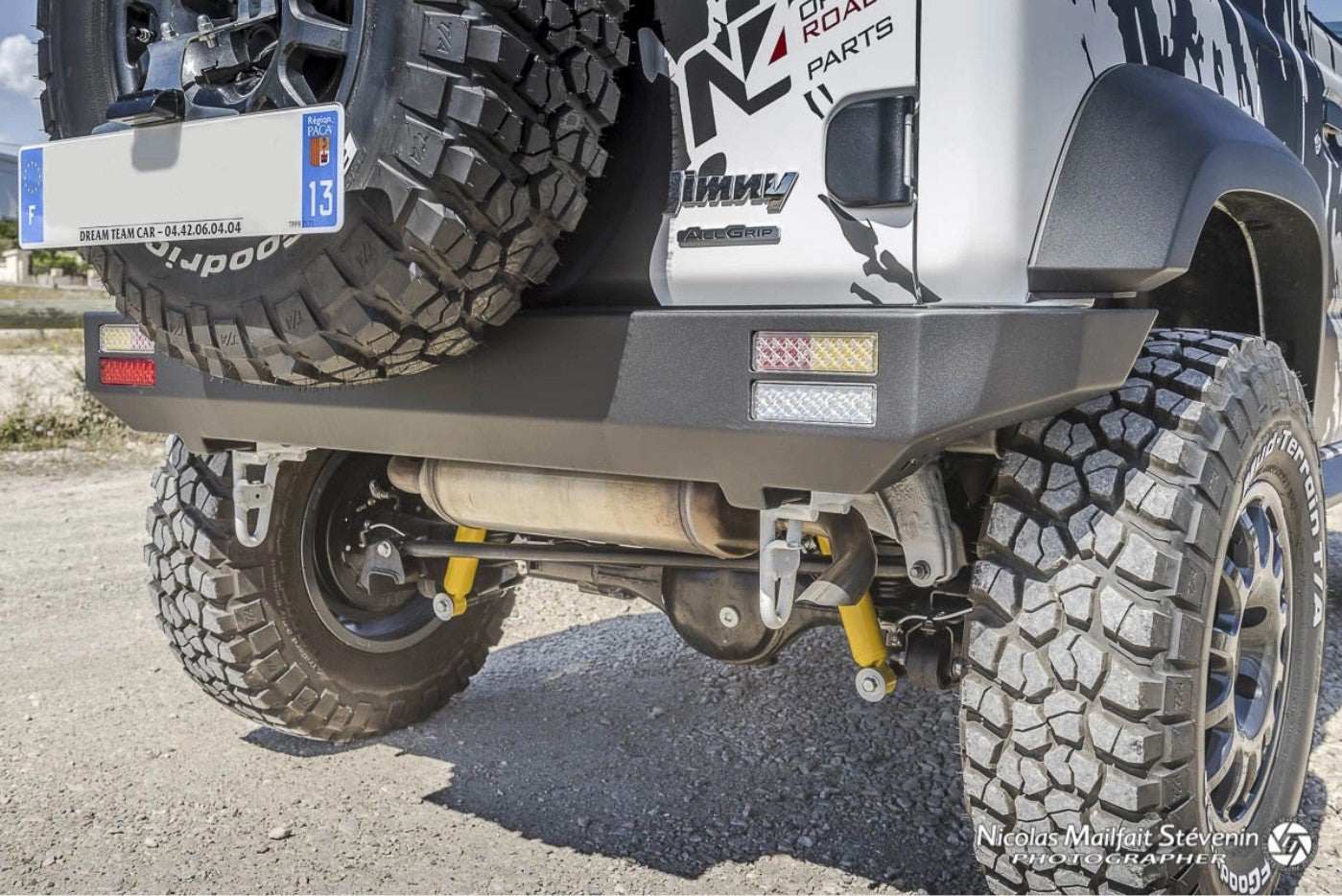 rear view of a jimny with yellow shock absorbers and steel bumper