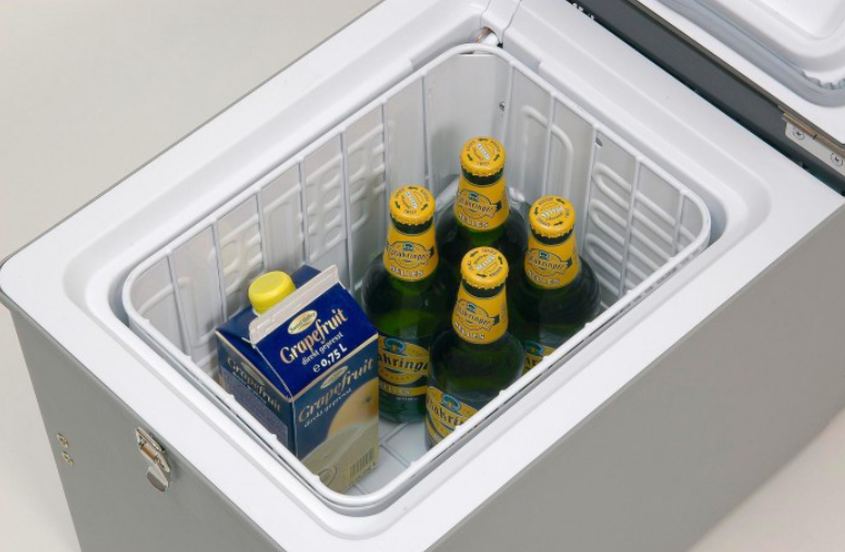 inside a small engel fridge with a white basket and food