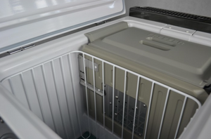 interior of an engel double compartment refrigerator with basket