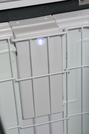 white inner basket of a fridge with a blue led