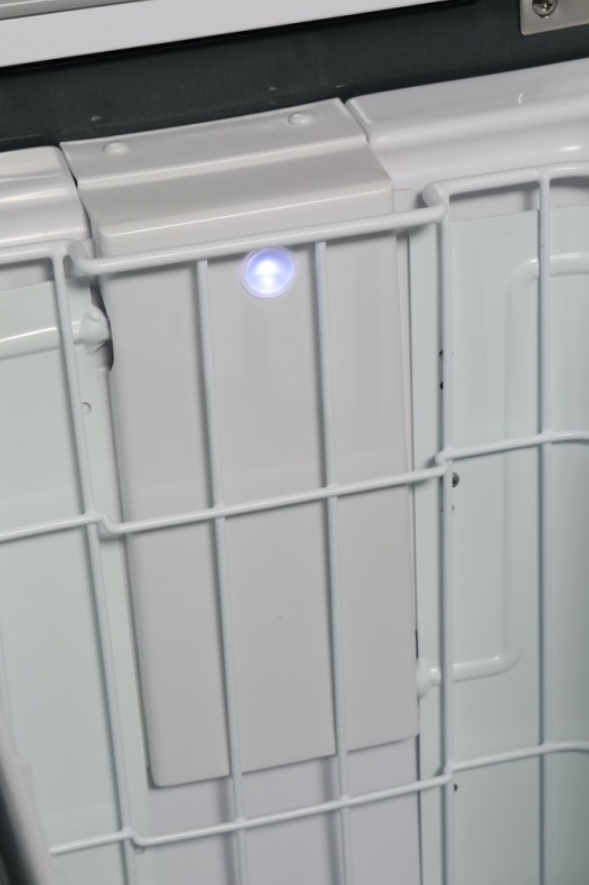 white inner basket of a fridge with a blue led