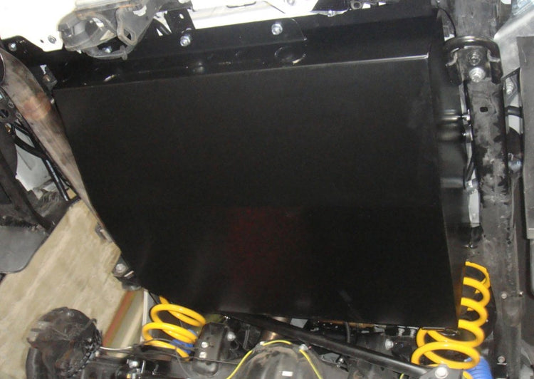 black tank mounted under a vehicle with two yellow springs behind it