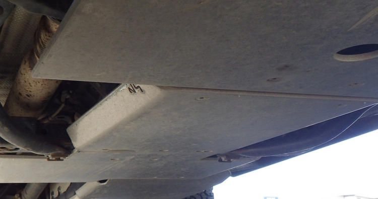 photo of N4 aluminum plates positioned under a rusty vehicle