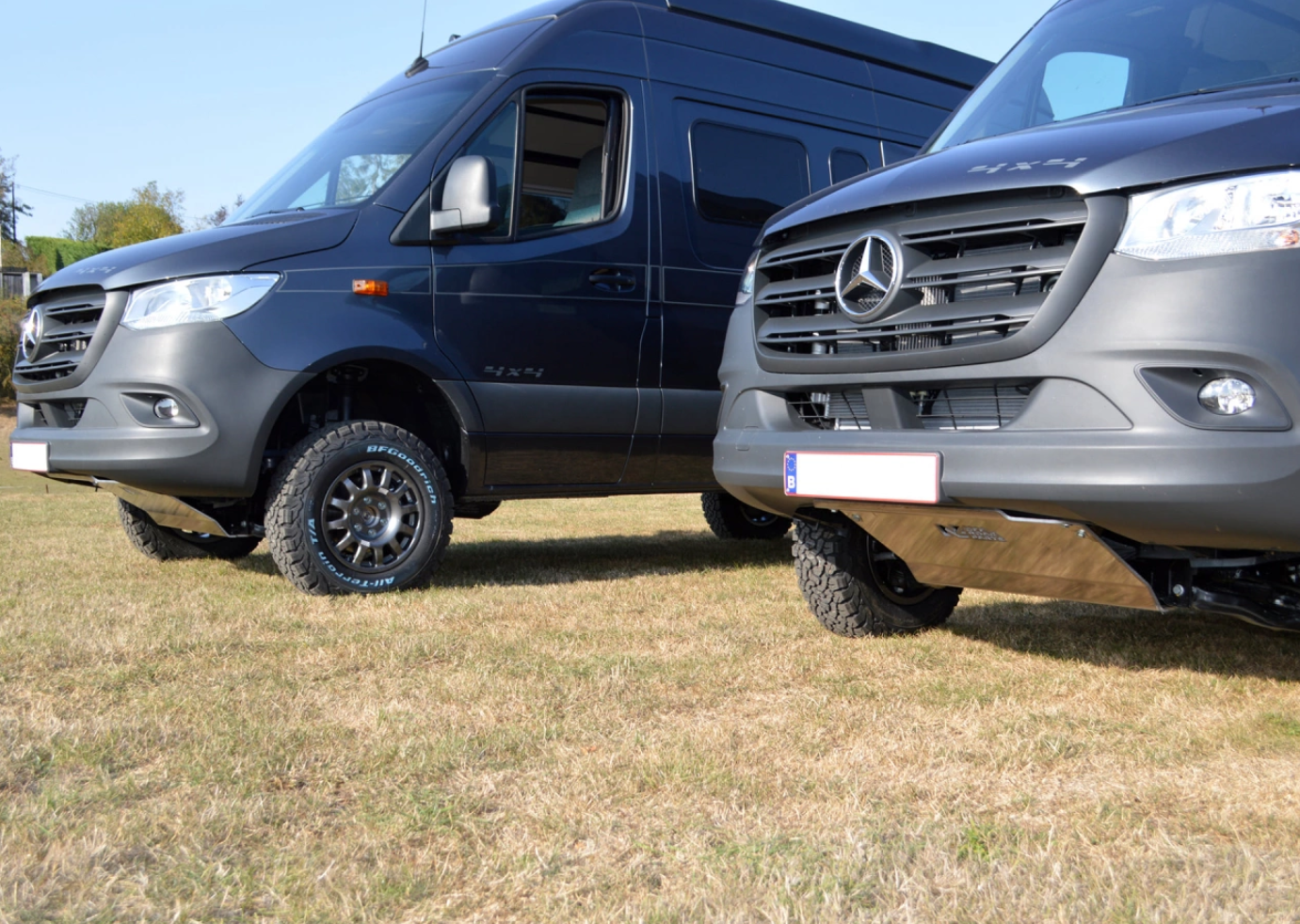 two mercedes sprinter parked in the grass with a front aluminium protection