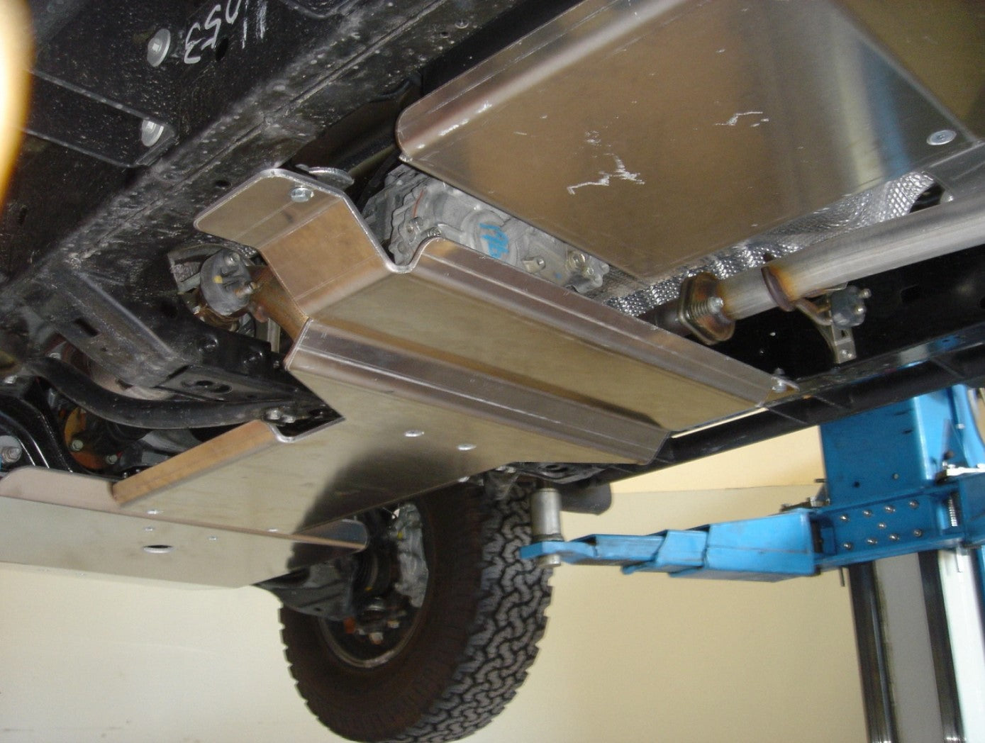 side view of the underside of a vehicle with aluminum skid plates