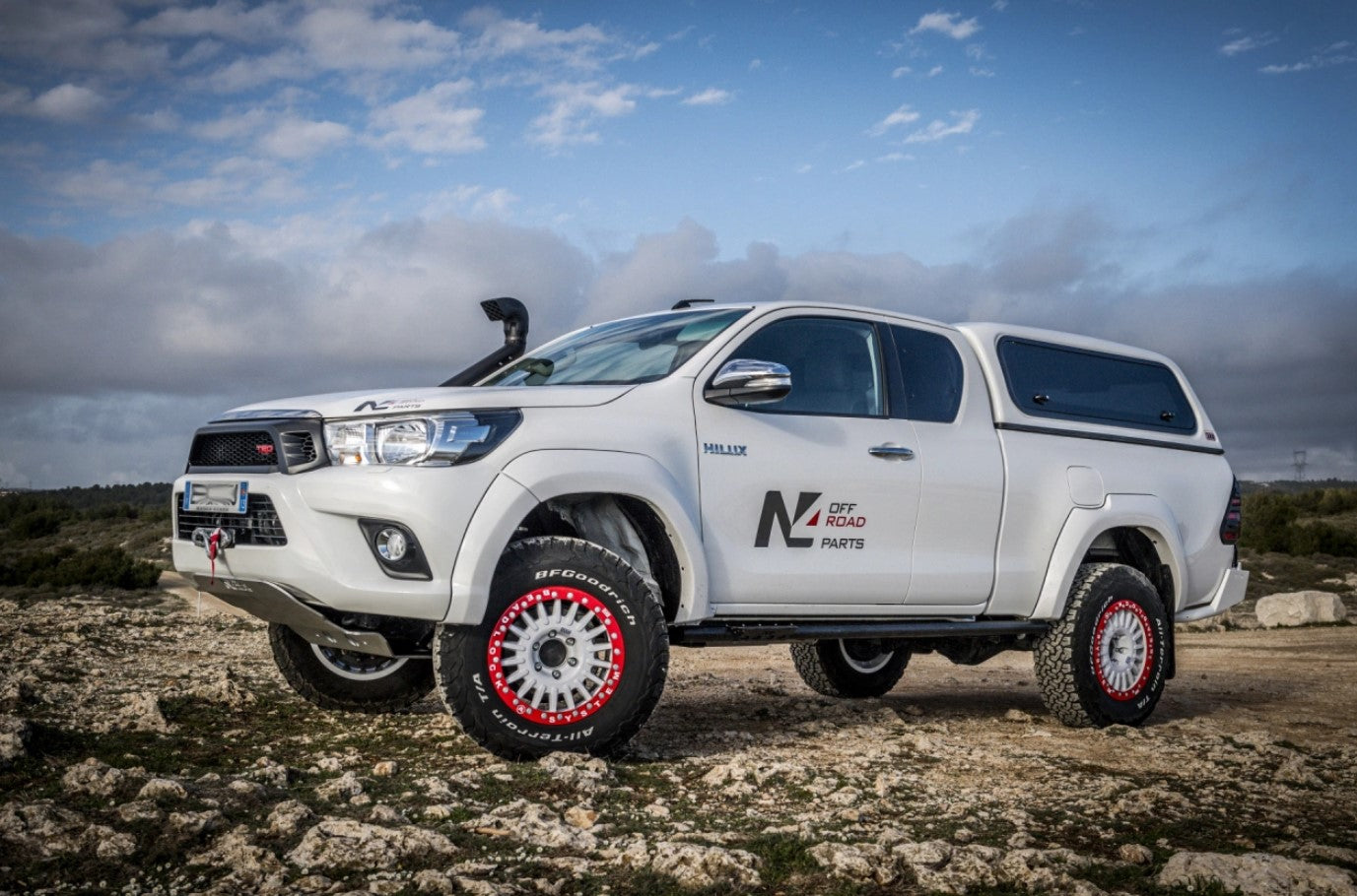 toyota hilux white with white and red wheels 