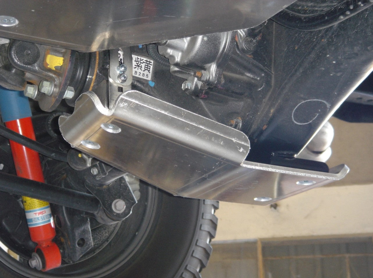 under a vehicle with a fixed aluminium guard