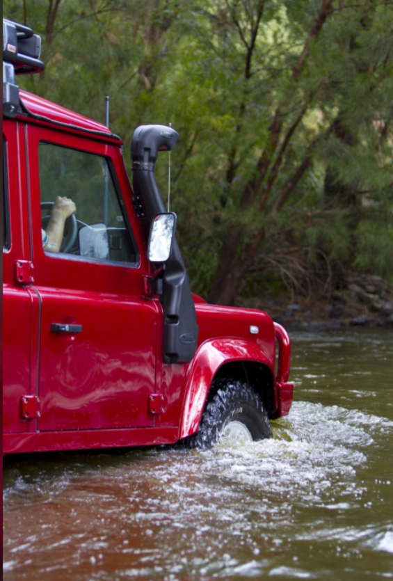 Defender 90 red in water with a snorkel
