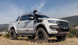 white ford ranger with a black snorkel on a mountainous landscape