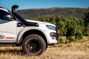 front of an armax pick up with a snorkel safari