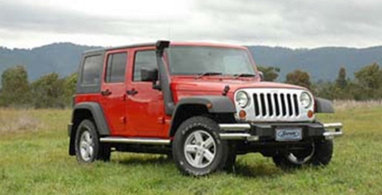jeep wrangler 3.8l jk red in a green landscape