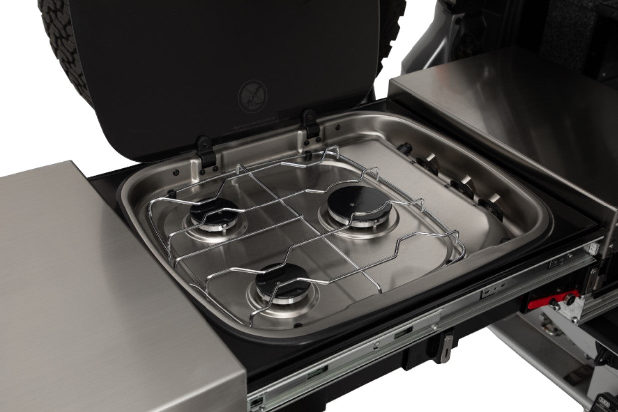 3-burner gas stove in front of a stainless steel worktop