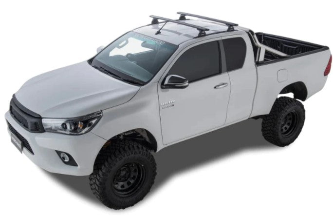 white pickup with two roof racks and the open Bed Truck