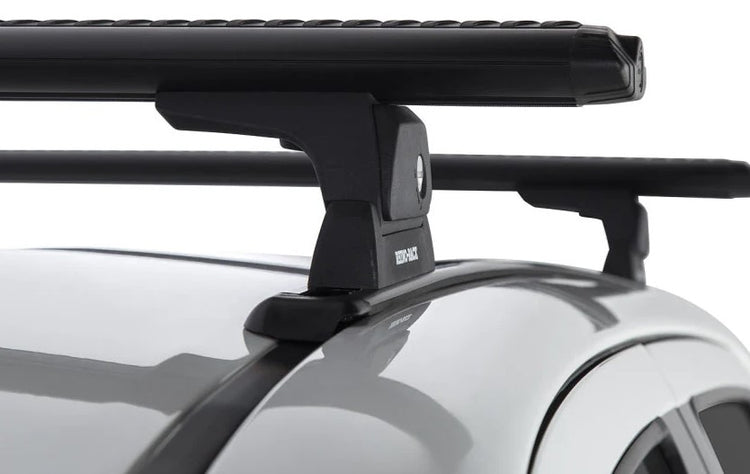 Two black vortex roof racks on rails and vehicles