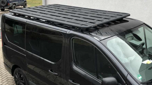 side view of a black renault trafic with a black roof rack