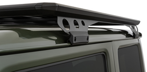 black roof rack attachment on a green vehicle roof