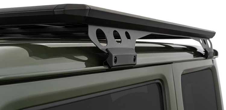 black roof rack attachment on a green vehicle roof