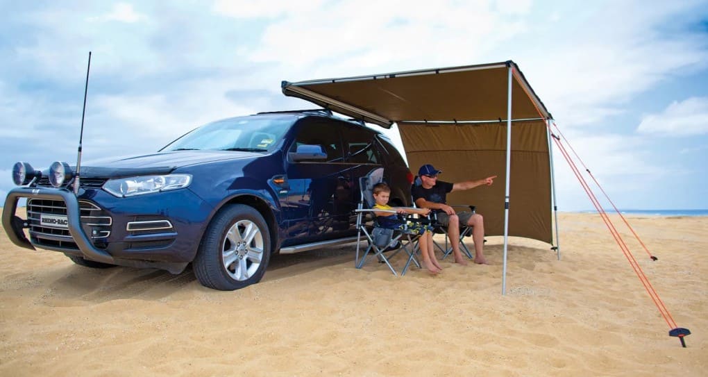 Two people talking under a Awning Rhinorack