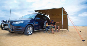 Two people talking under a Awning Rhinorack