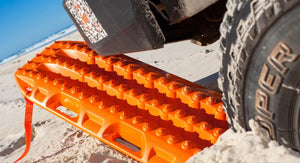 orange sand plate under a 4x4 wheel