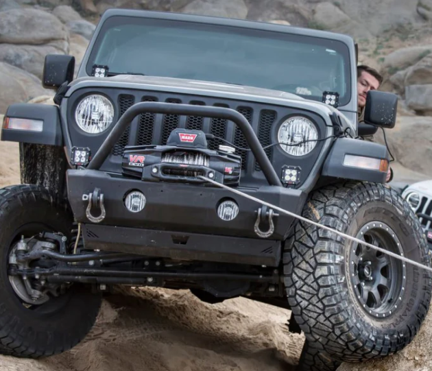 Black Jeep wrangler pulled by a winch warn